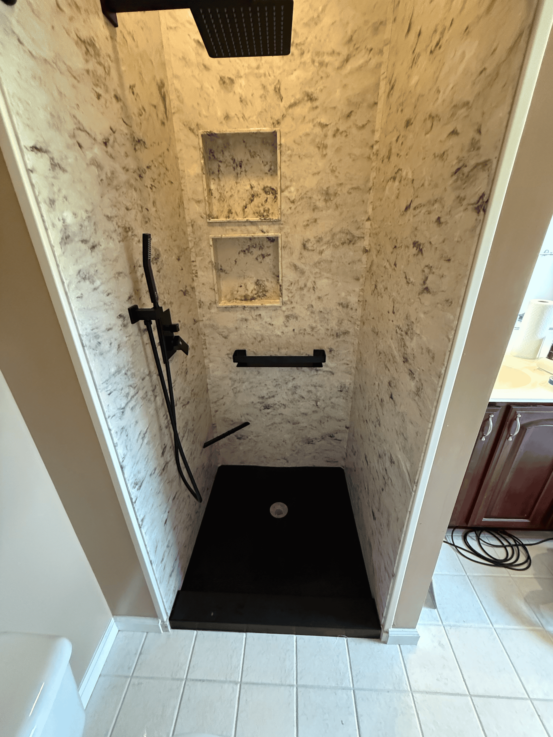 Modern shower with built-in niches for toiletries.