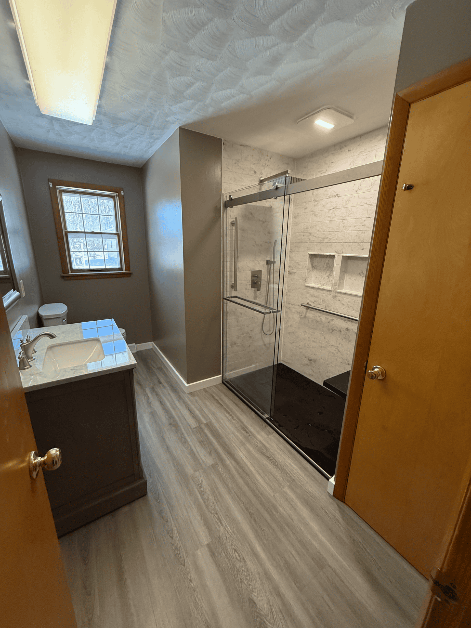 Modern bathroom with walk-in shower and vanity.