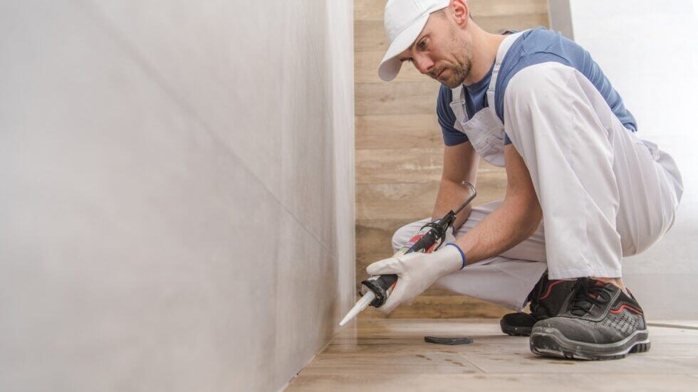 Skilled worker applying wall patching compound in a home renovation project.