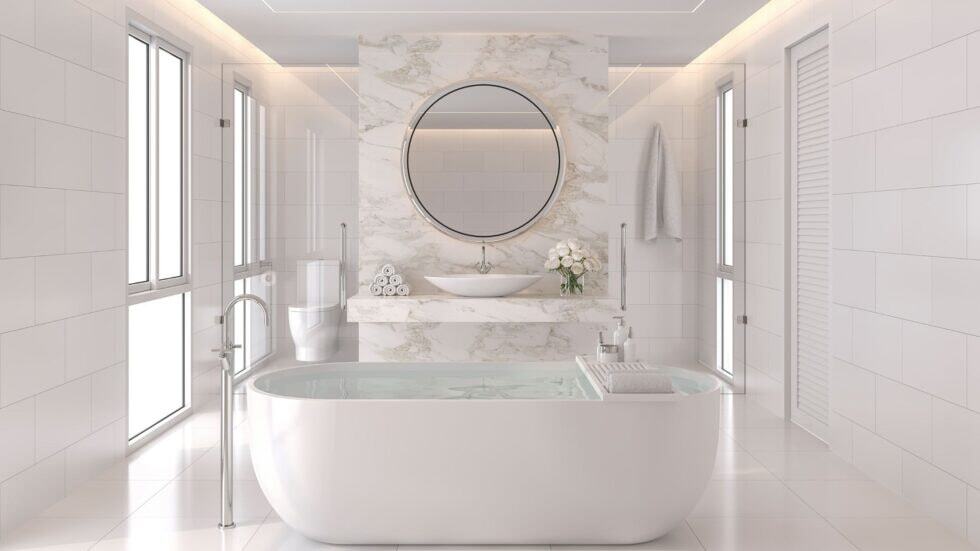 Elegant white bathroom with a freestanding bathtub and marble accents.