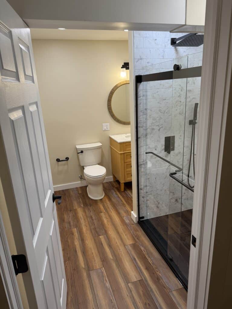 Modern bathroom with toilet and glass shower enclosure.