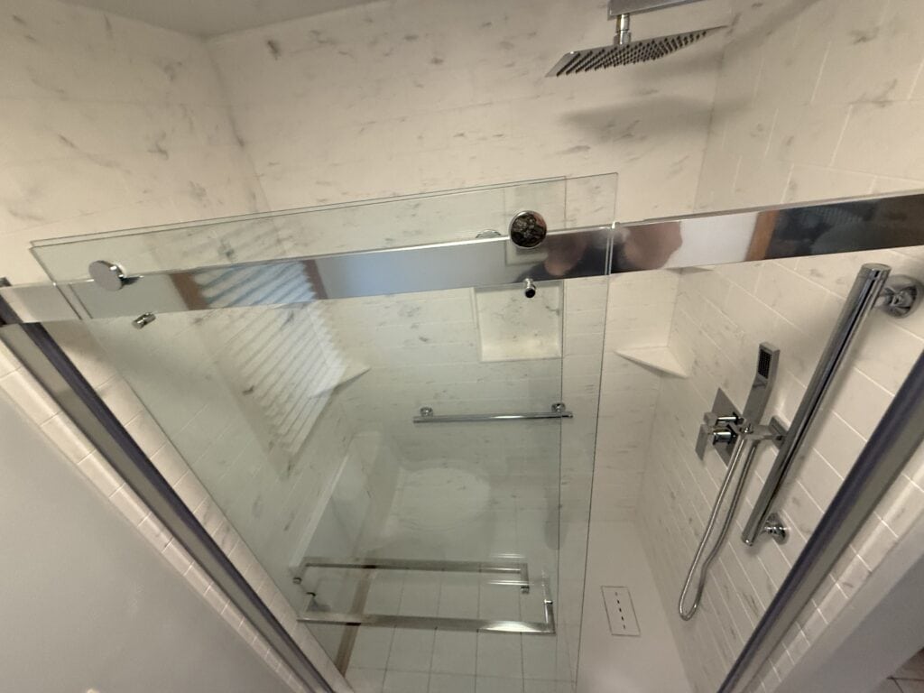 Modern glass shower enclosure with sleek fixtures.