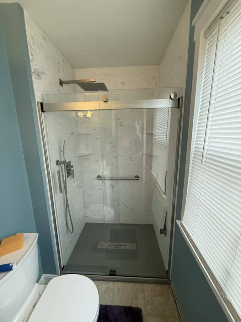 Walk-In Shower with Glass Door and Rain Showerhead.