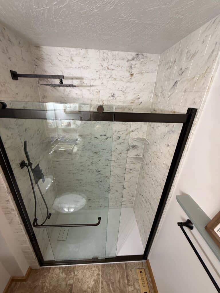 Modern walk-in shower with glass enclosure and sleek fixtures.