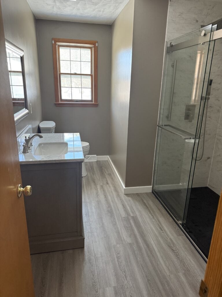 Bathroom with shower enclosure and vanity.