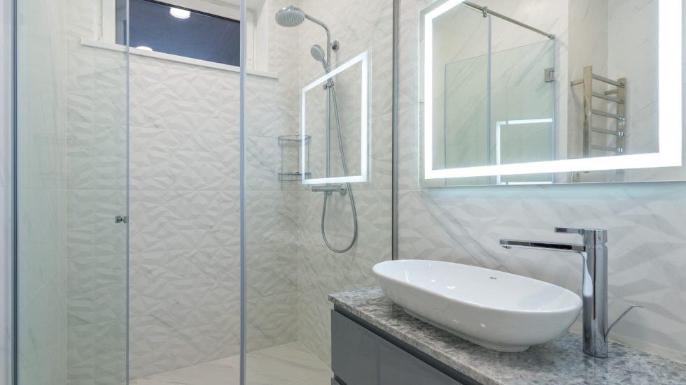 Bright, modern bathroom with walk-in shower and stylish vessel sink. Perfect for contemporary home u.