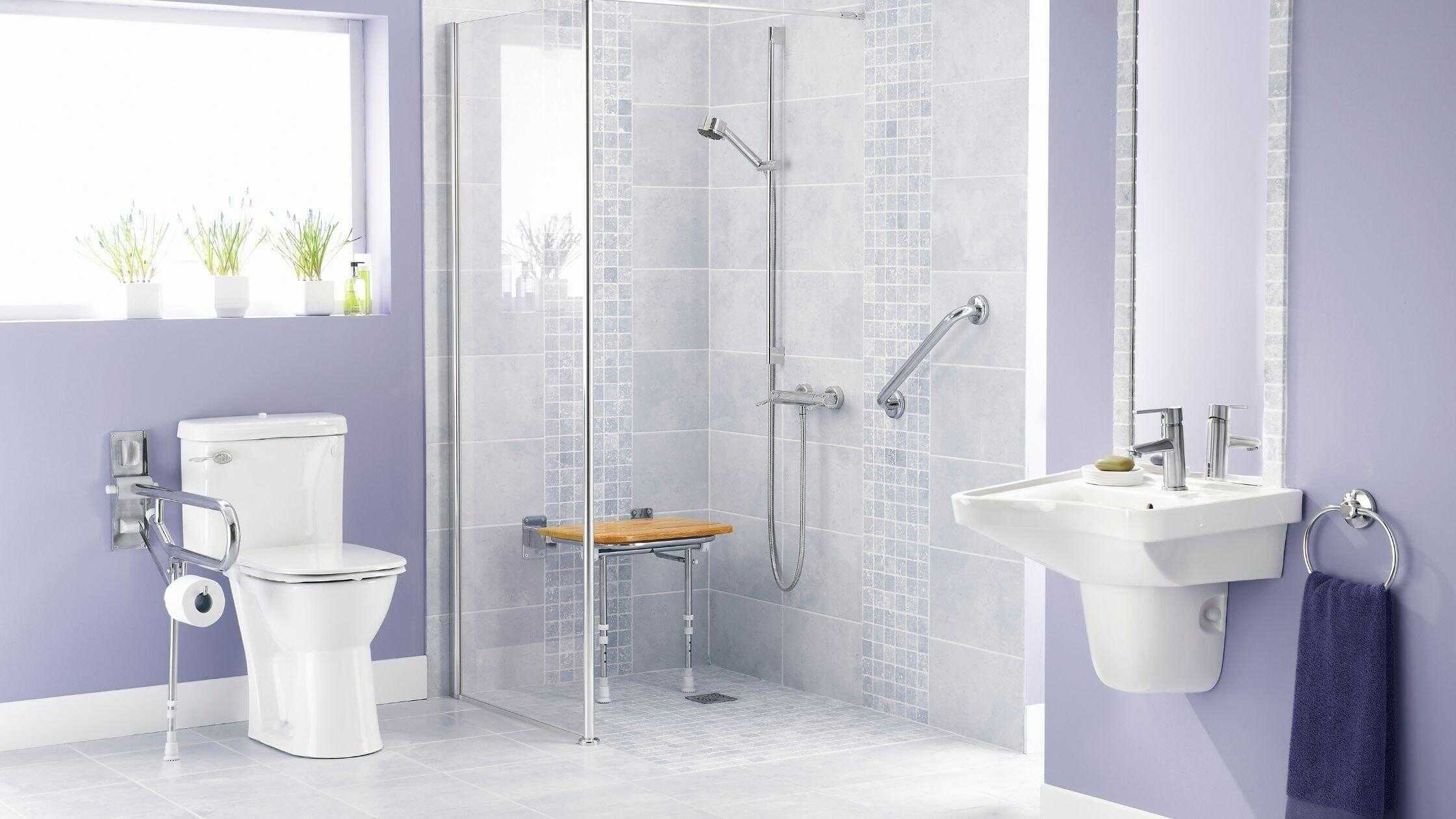 Bright modern bathroom with walk-in shower, toilet, and sink in a stylish purple-themed space.